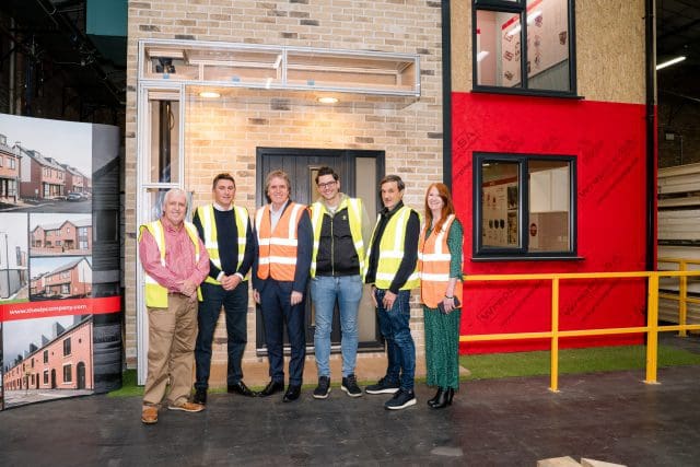 Mayor Steve Rotheram and the Adaptahaus by SIPCO team outside their model Hybrid System House